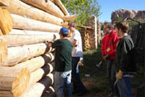Volunteers working on cabin chinking